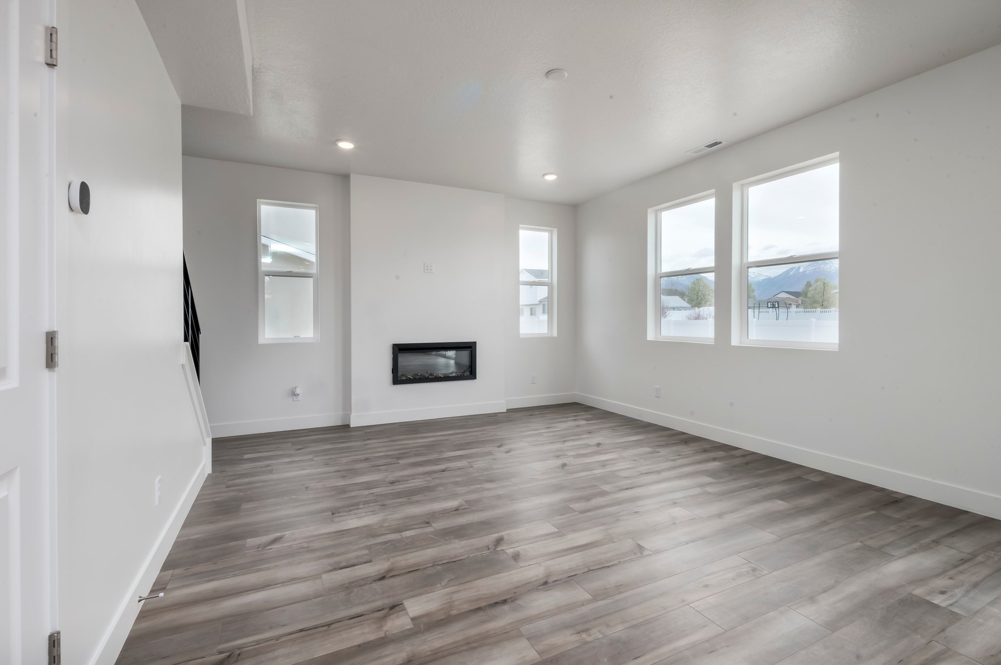 A room with a wood floor and white walls.