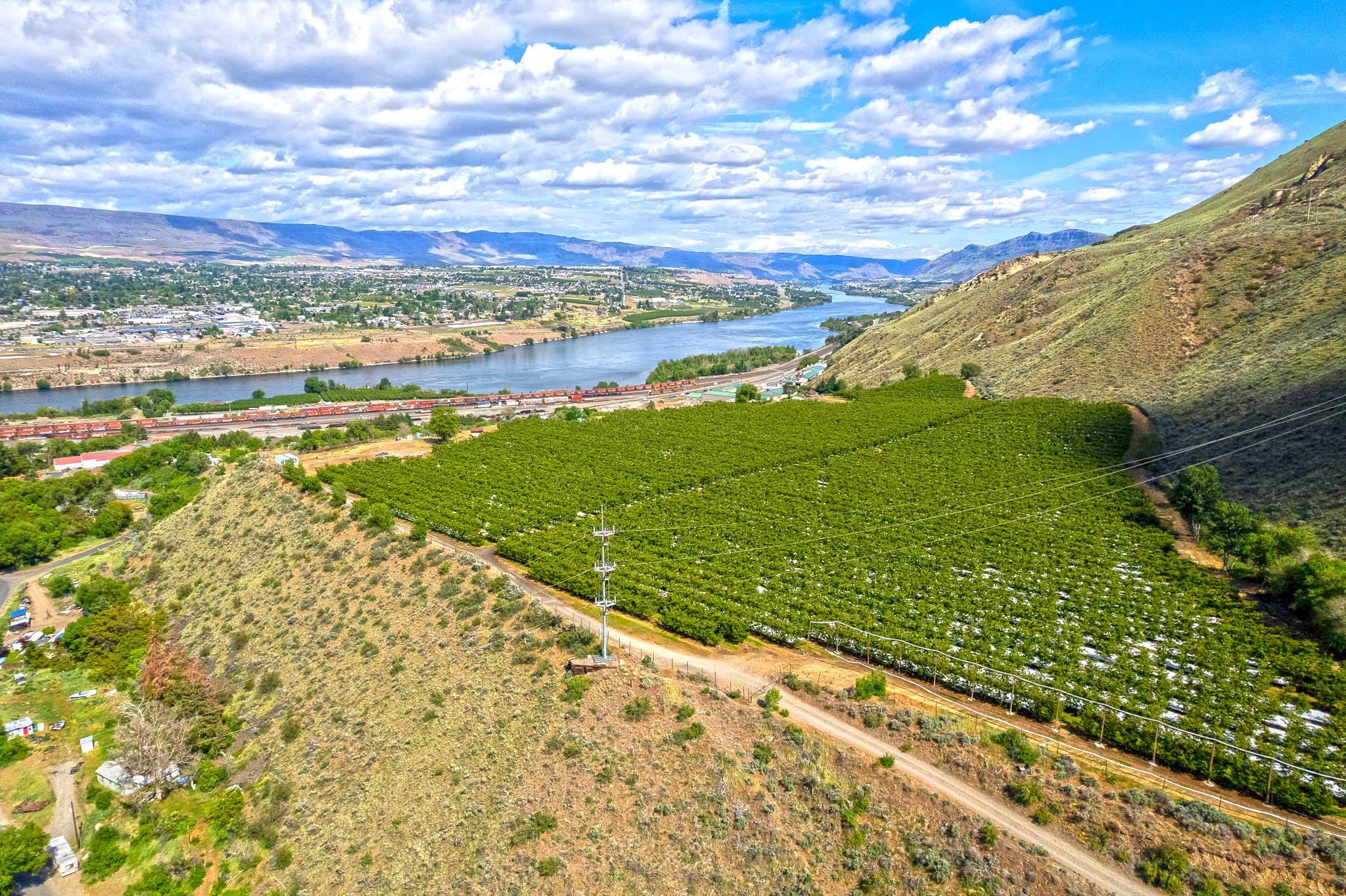A landscape with a body of water and a land with a road.