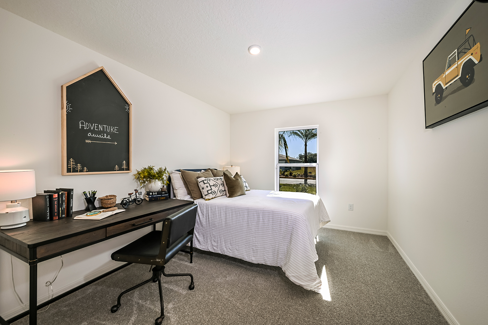 A bedroom with a bed desk and chair.