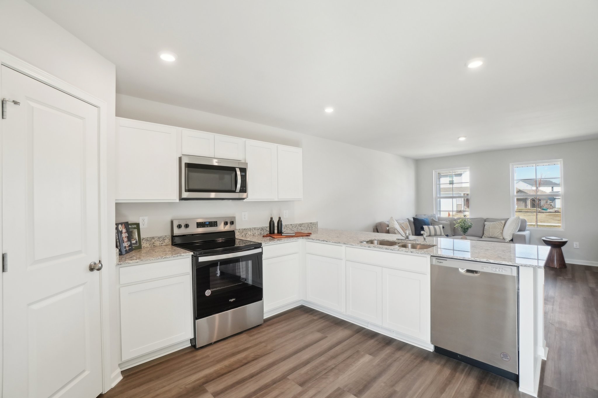 A kitchen with white cabinets.