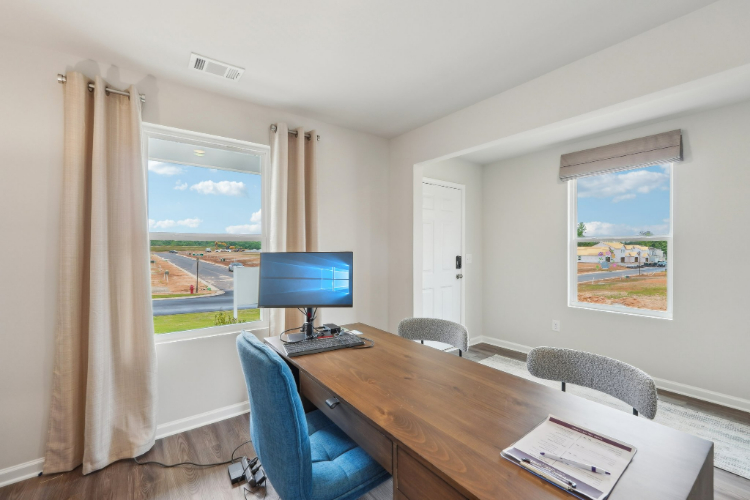 A room with a desk and a computer.