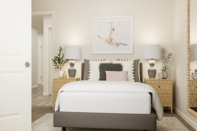 A bedroom with a bed and lamps.